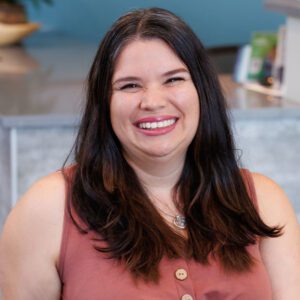 Christina wearing a pink top and smiling at the camera