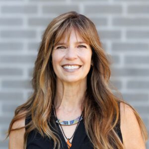 Darla wearing a black top and smiling at the camera